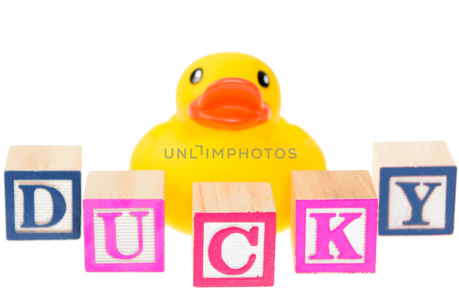 Baby blocks spelling ducky with a rubber duck. Isolated on a white background