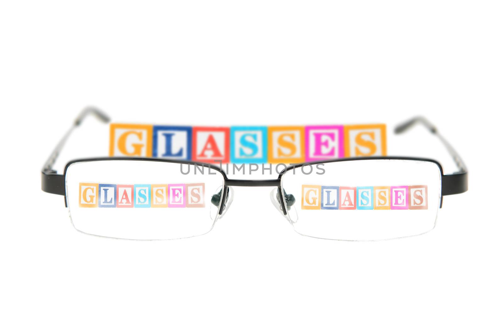 Letter blocks spelling glasses with a pair of glasses. by dragon_fang