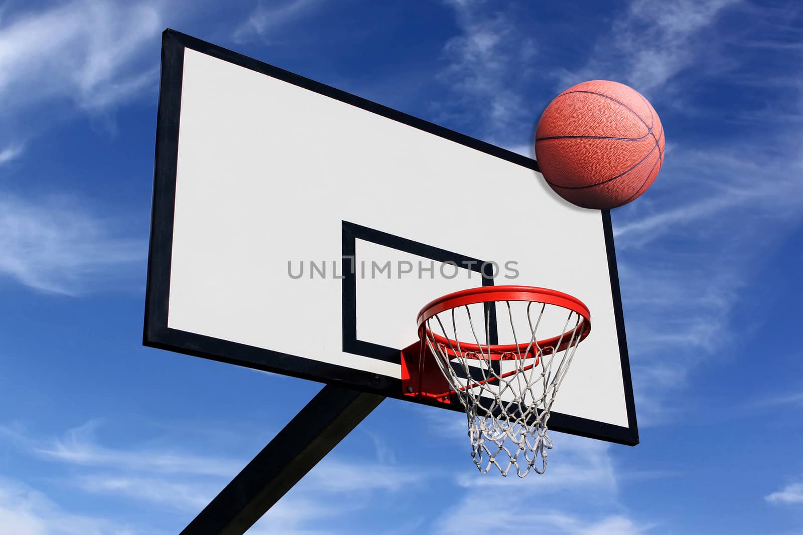 a basketball and a panel of basketball on a background of blue sky