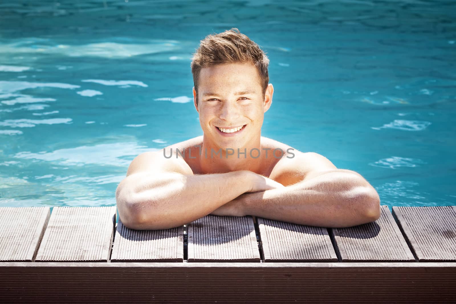 An image of a handsome man in the pool