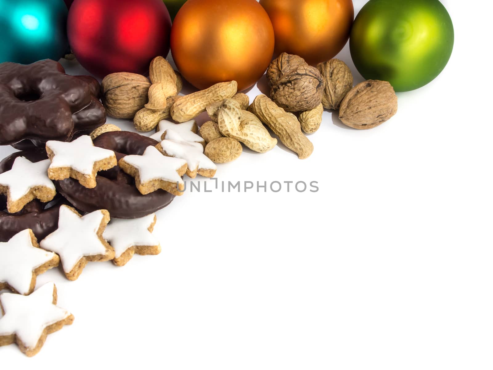 Gingerbread, cinnamon stars, nuts and colorful Christmas baubles