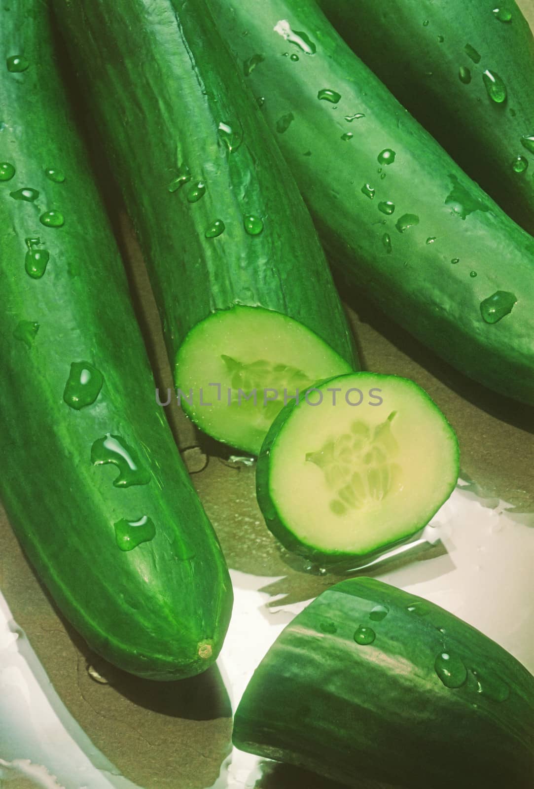 fresh green cucumbers on the glass table