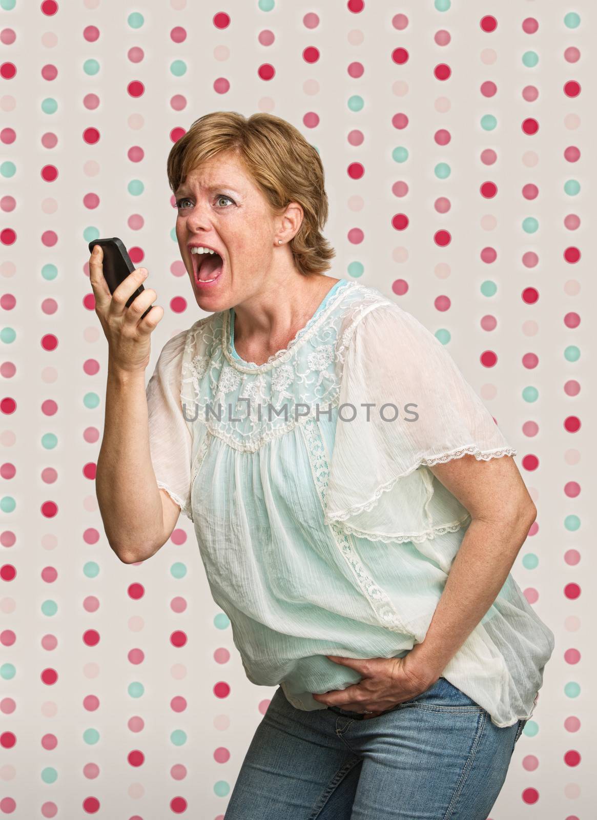 Pretty young pregnant woman on polka dot background