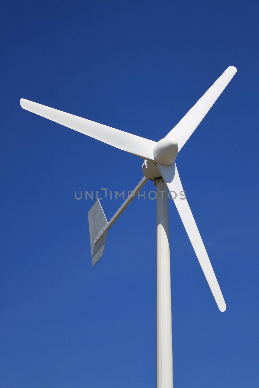 a wind turbine for renewable energy on a background of blue sky