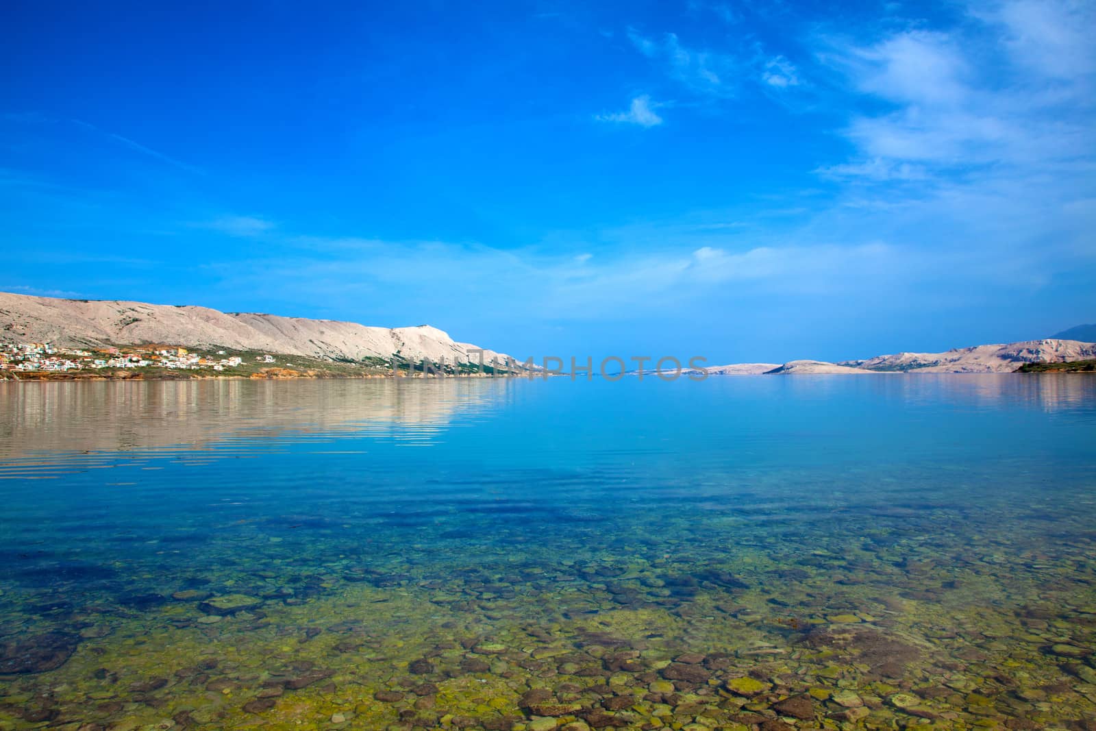 dalmatian part of the Adriatic coast and rocky beach, with blue sky  in Pag in Croatia.