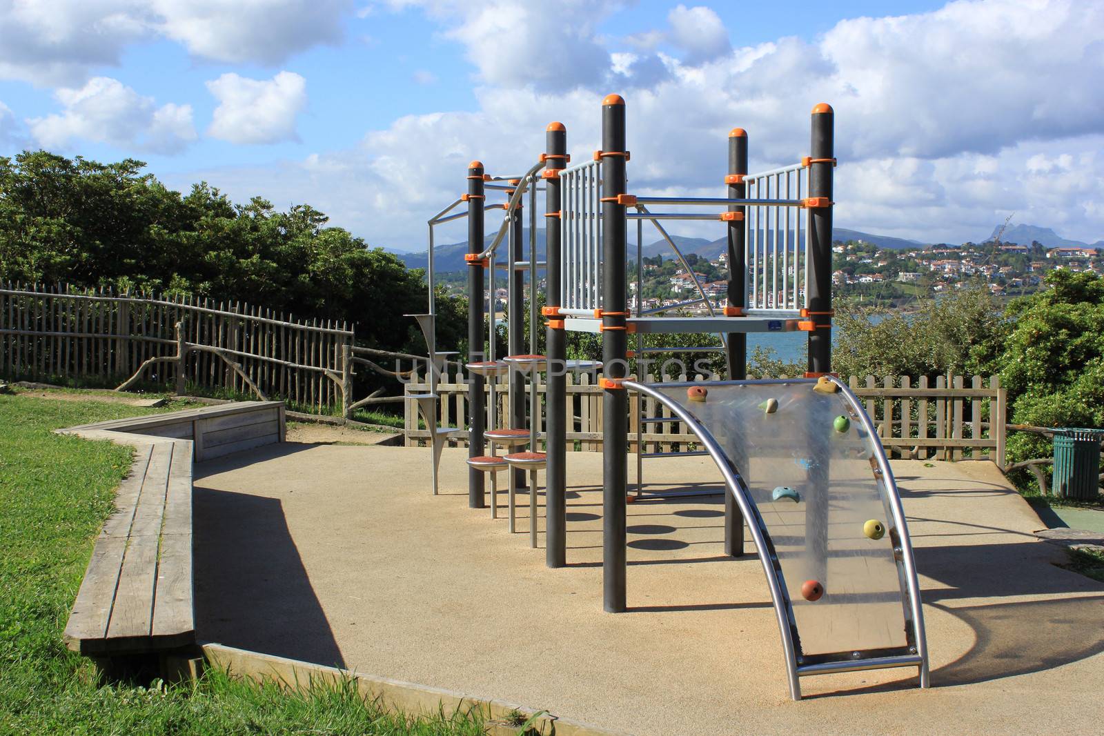 a playground in an amusement park near the sea over a mountain