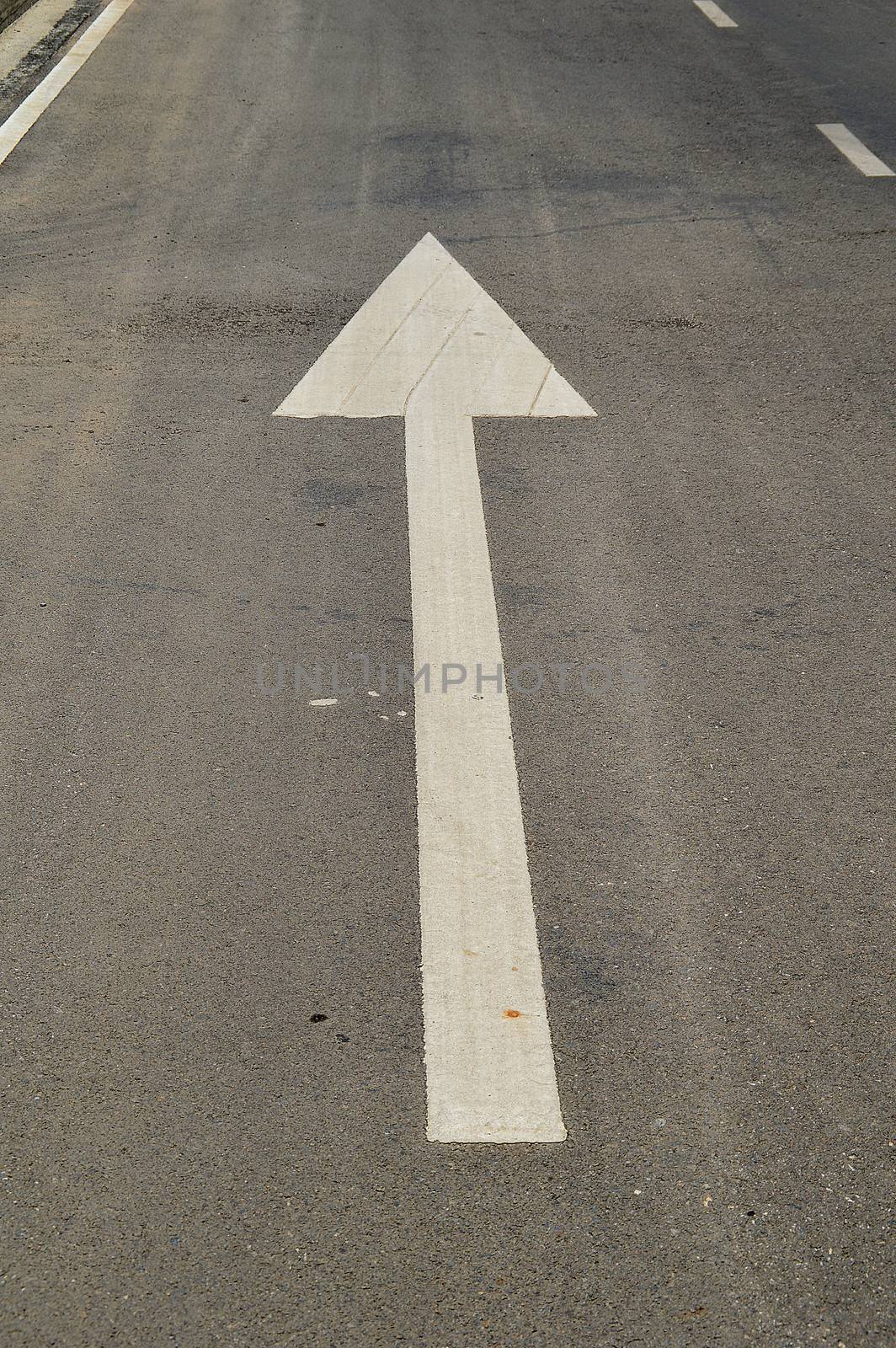 arrow signs on the asphalt road