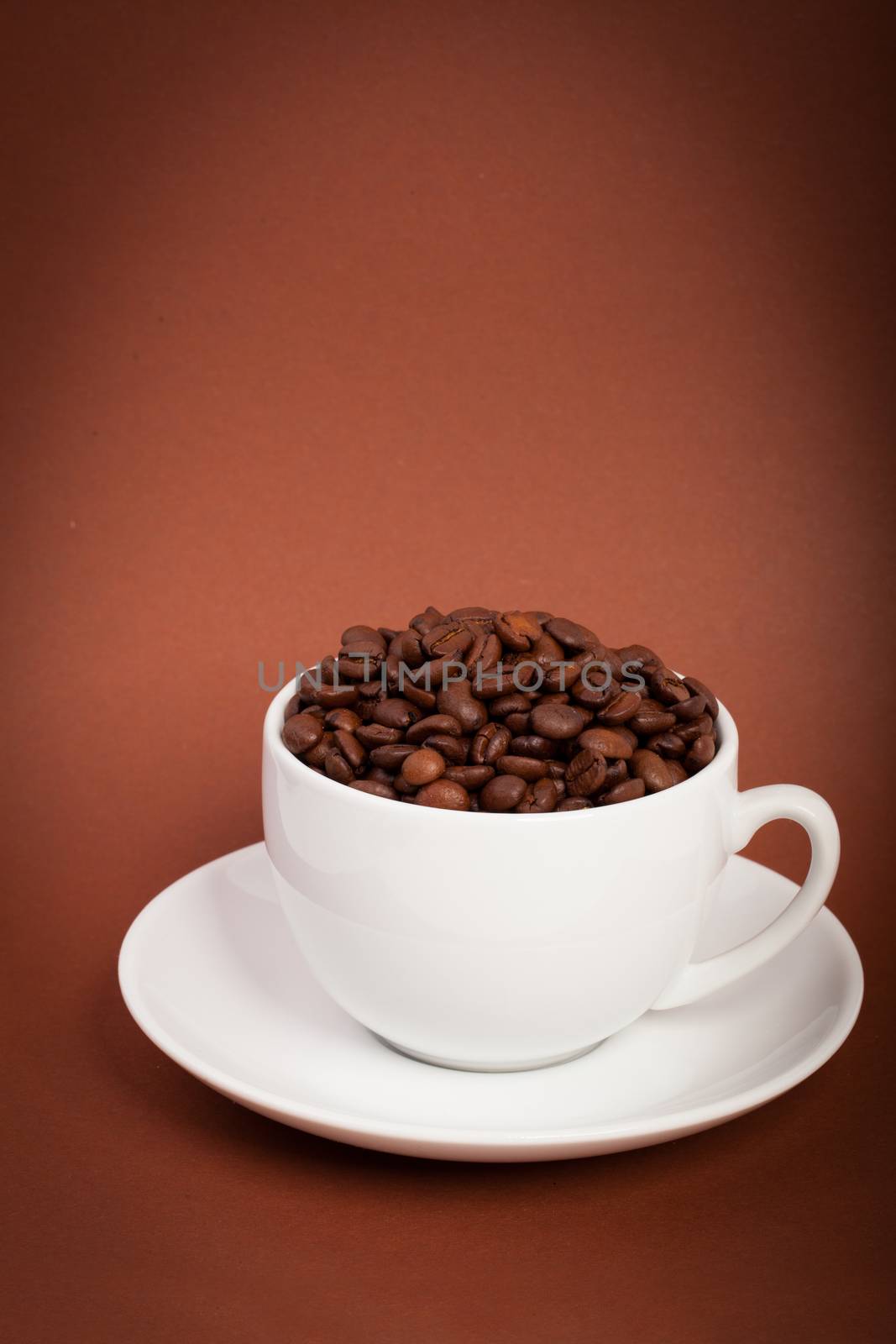 cup with coffee beans on a dark background by motorolka