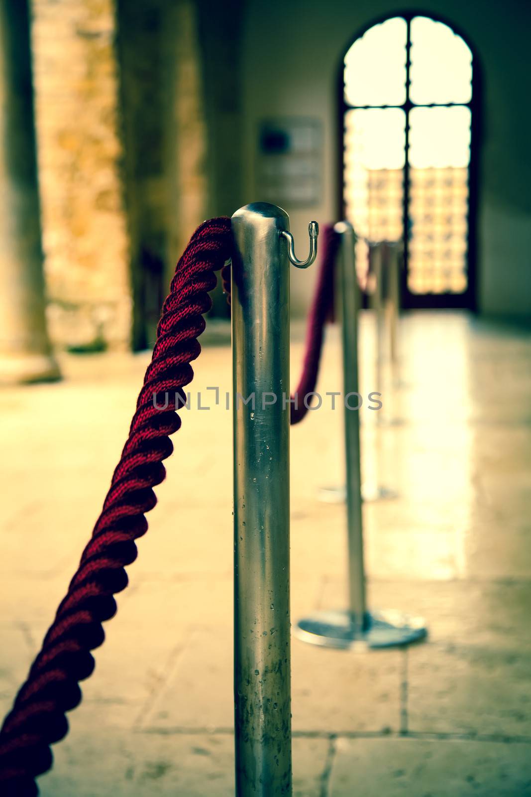 Red barrier rope on window background. event object by motorolka