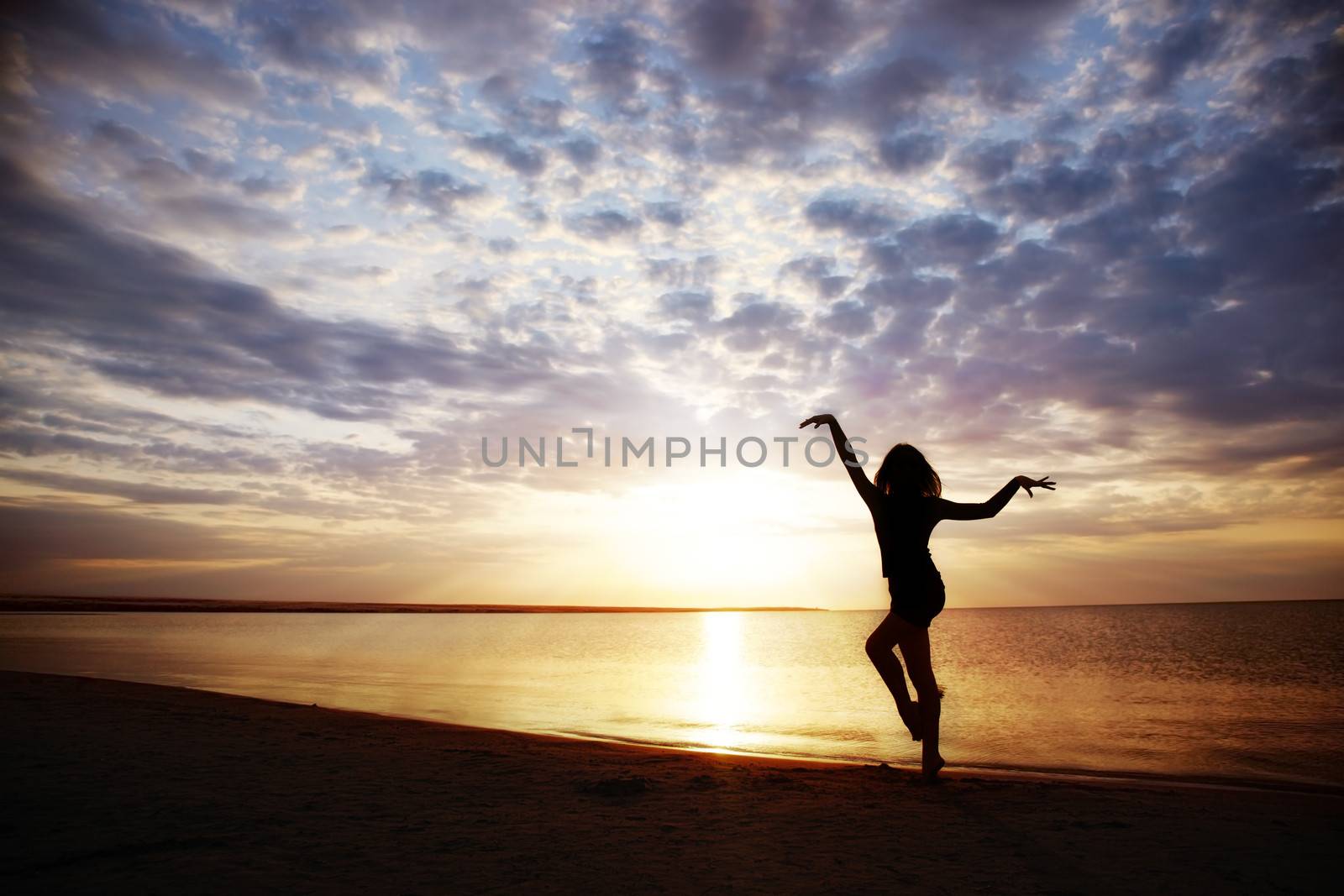 Woman doing healthy exercise during sunset