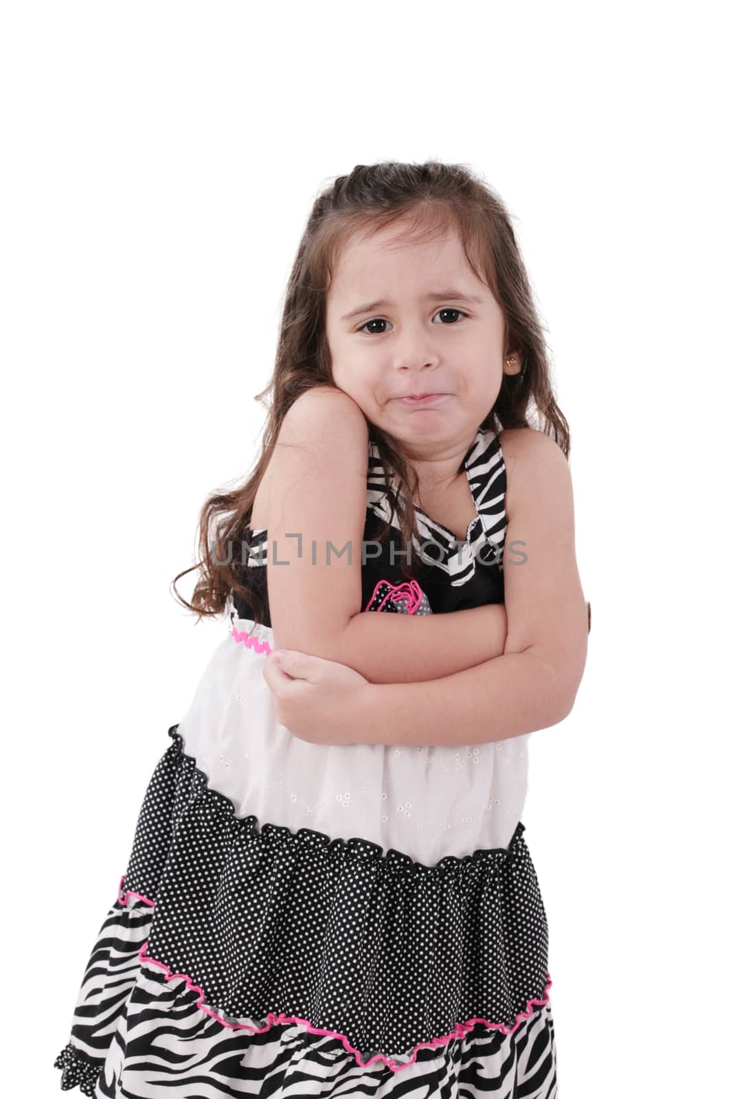 angry little girl in dress with arms crossed on white background by dacasdo