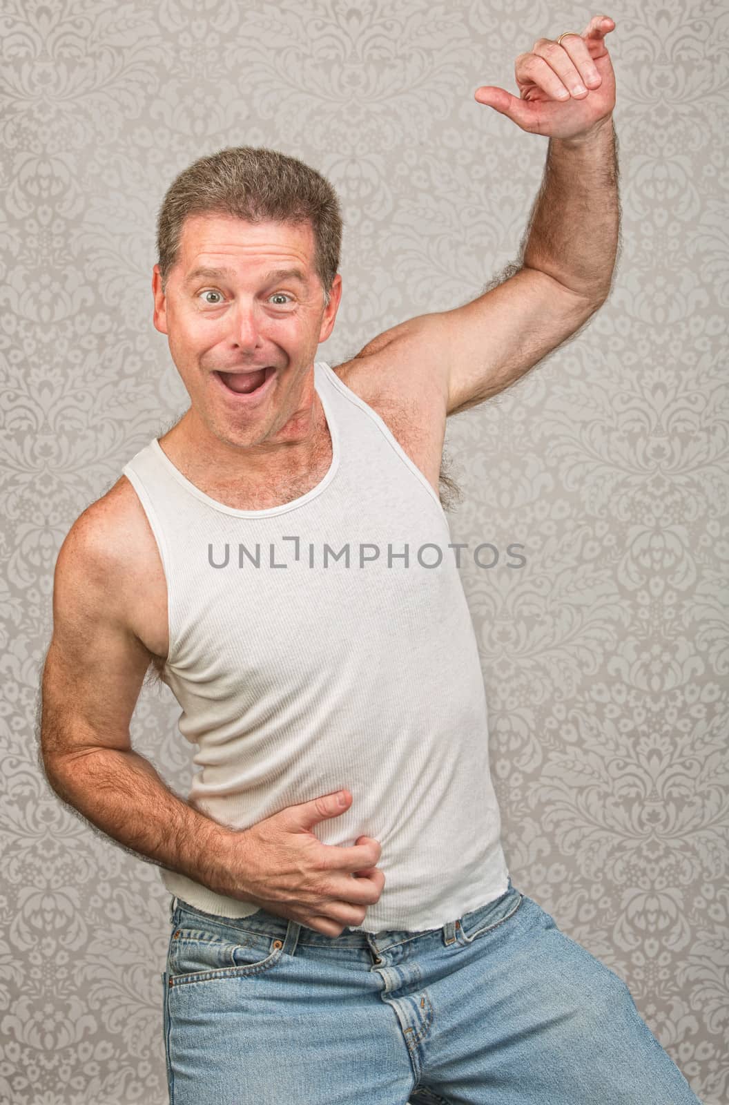 Dancing Caucasian man in blue jeans and undershirt
