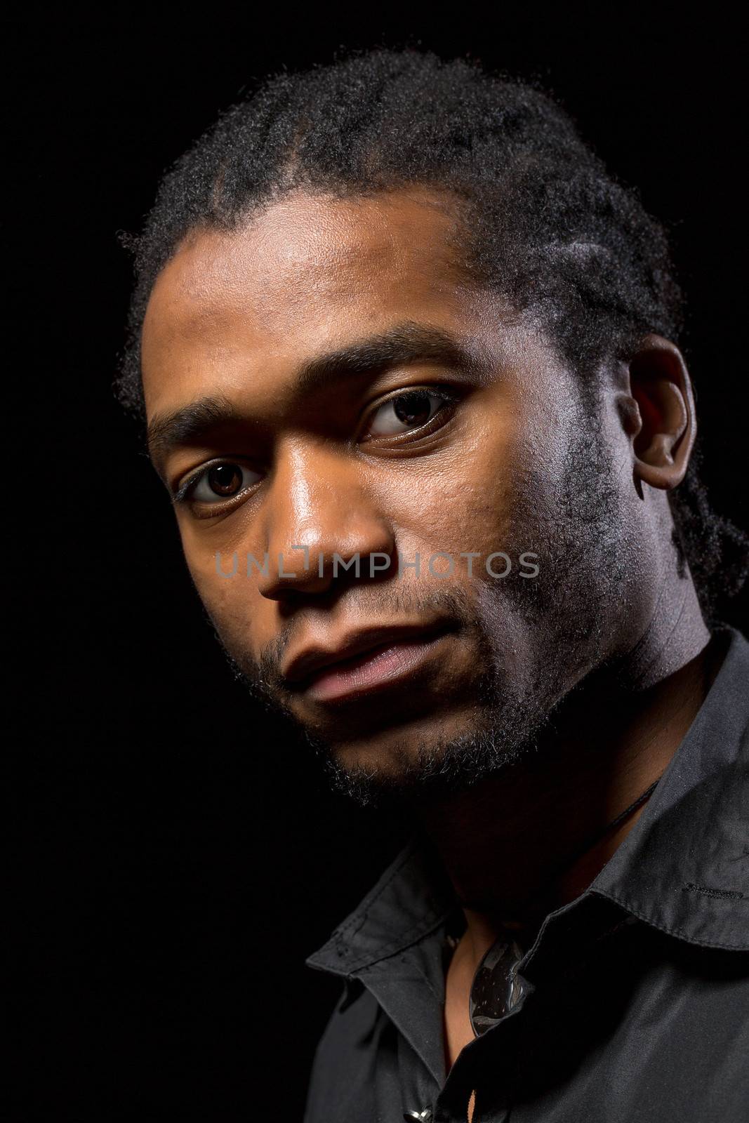 Portrait of a handsome African-American on a black background