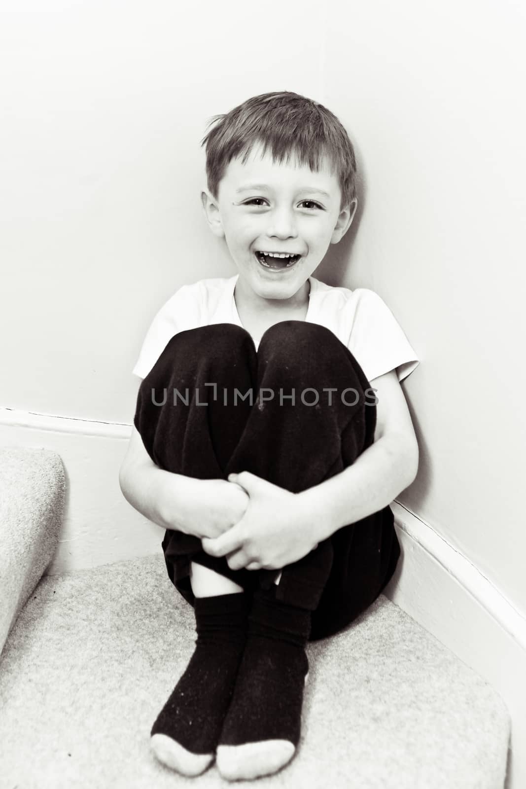Happy 5 year old boy in black and white