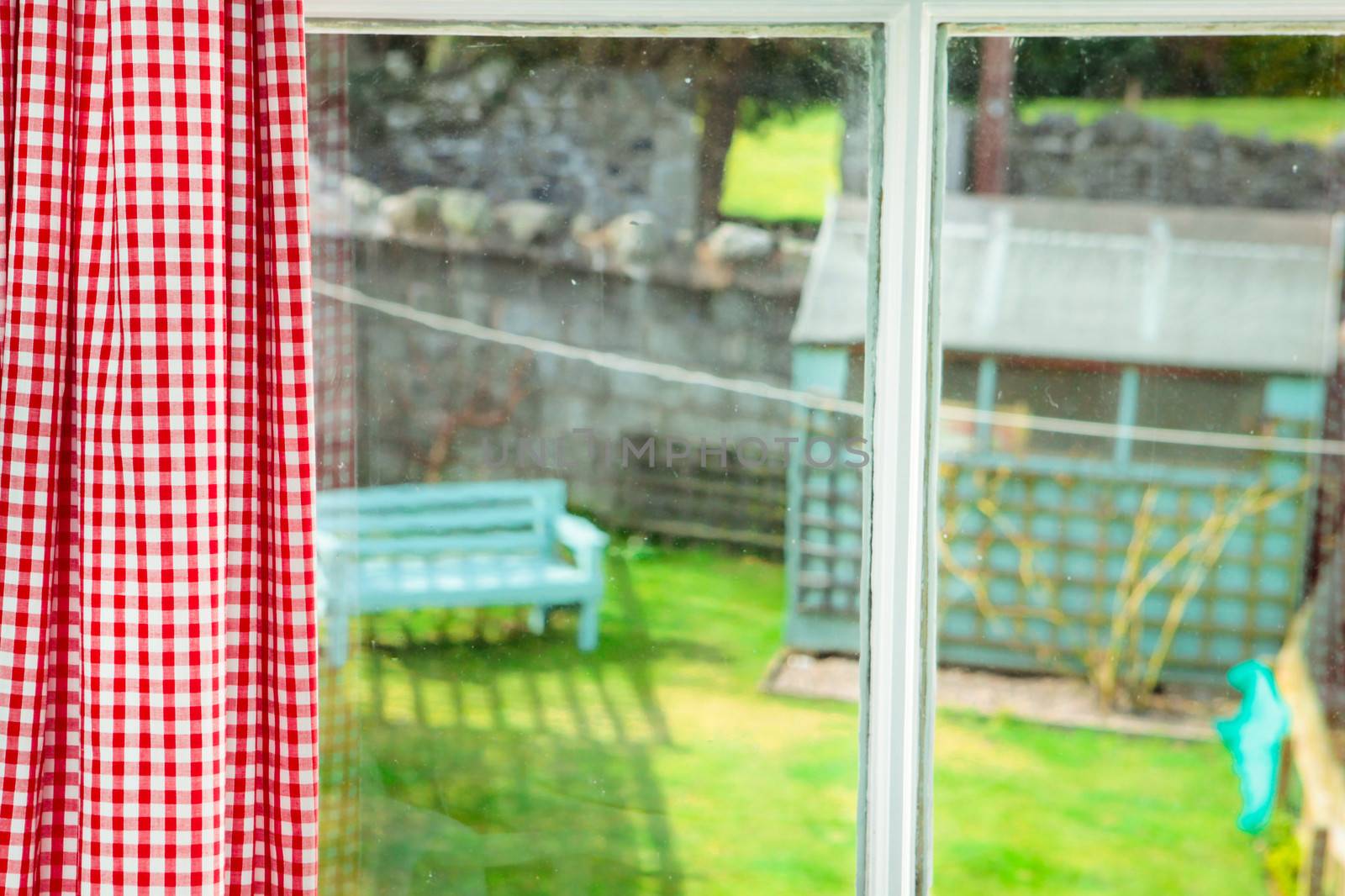 View out of a bedroom window into a cottage garden