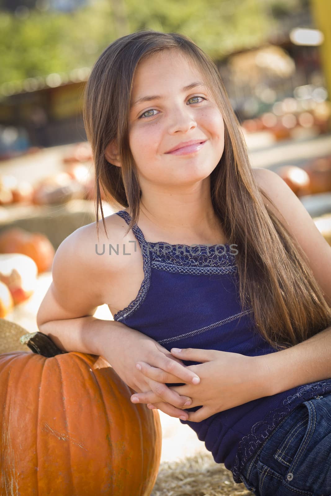 Preteen Girl Portrait at the Pumpkin Patch in a Rustic Setting.