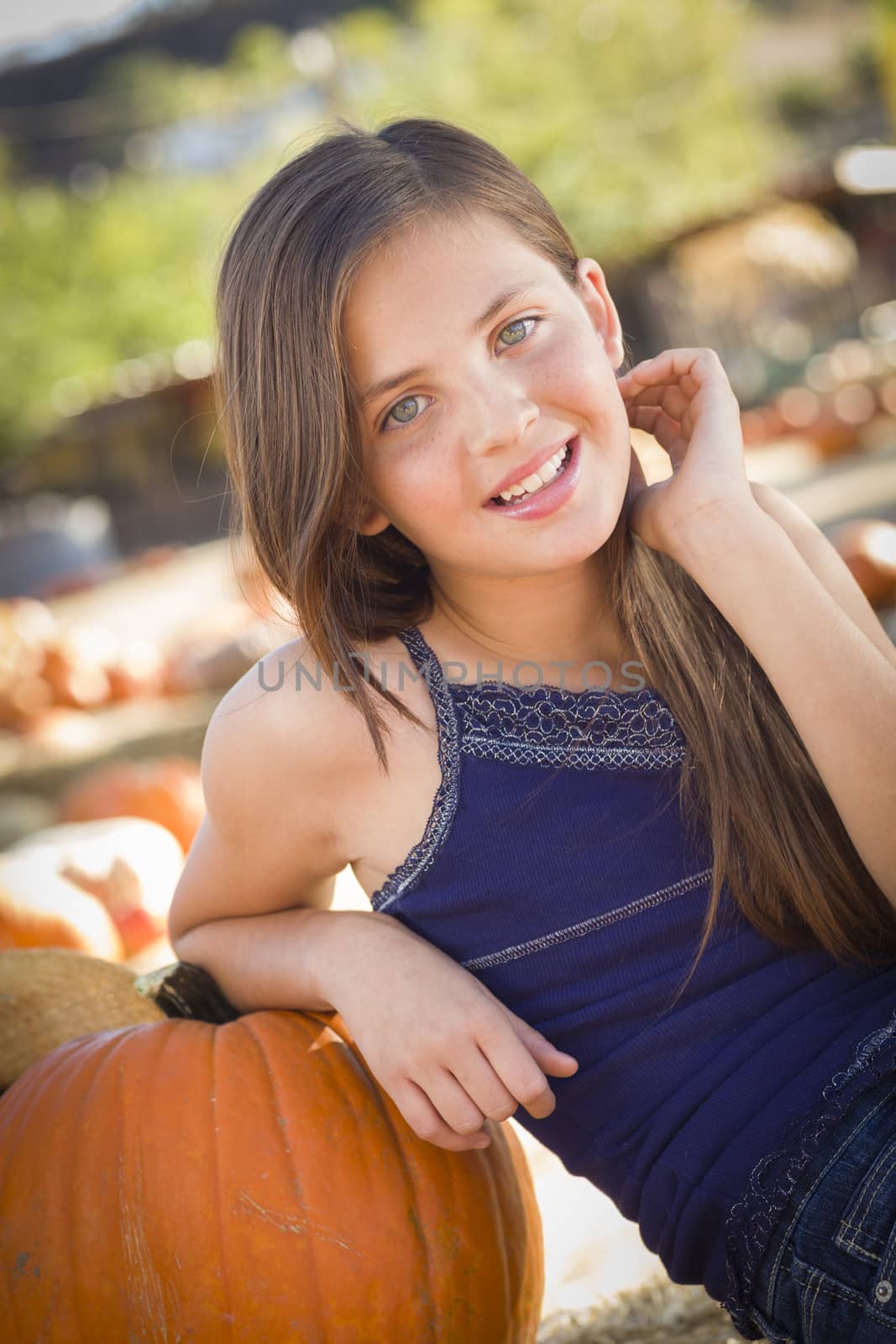 Preteen Girl Portrait at the Pumpkin Patch in a Rustic Setting.