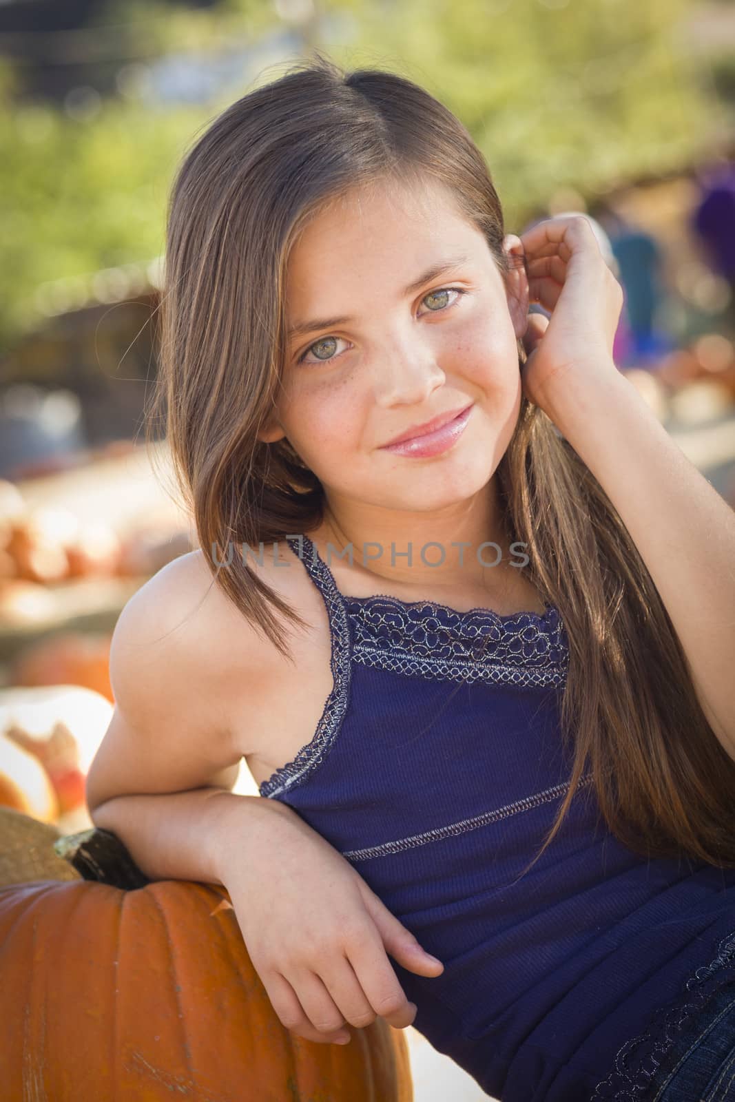 Preteen Girl Portrait at the Pumpkin Patch in a Rustic Setting.