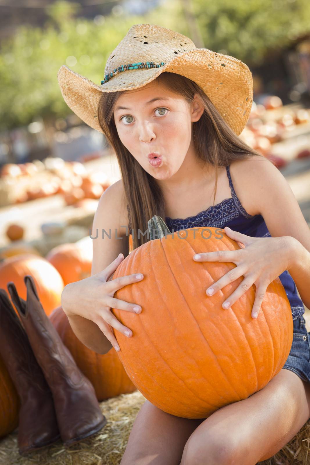 Preteen Girl Holding A Large Pumpkin at the Pumpkin Patch
 by Feverpitched