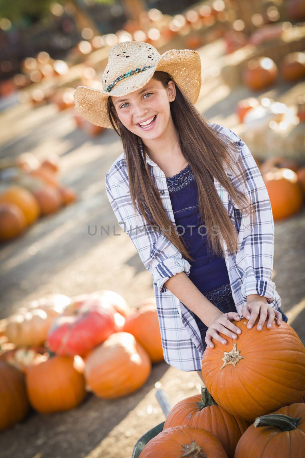 Preteen Girl Playing with a Wheelbarrow at the Pumpkin Patch
 by Feverpitched