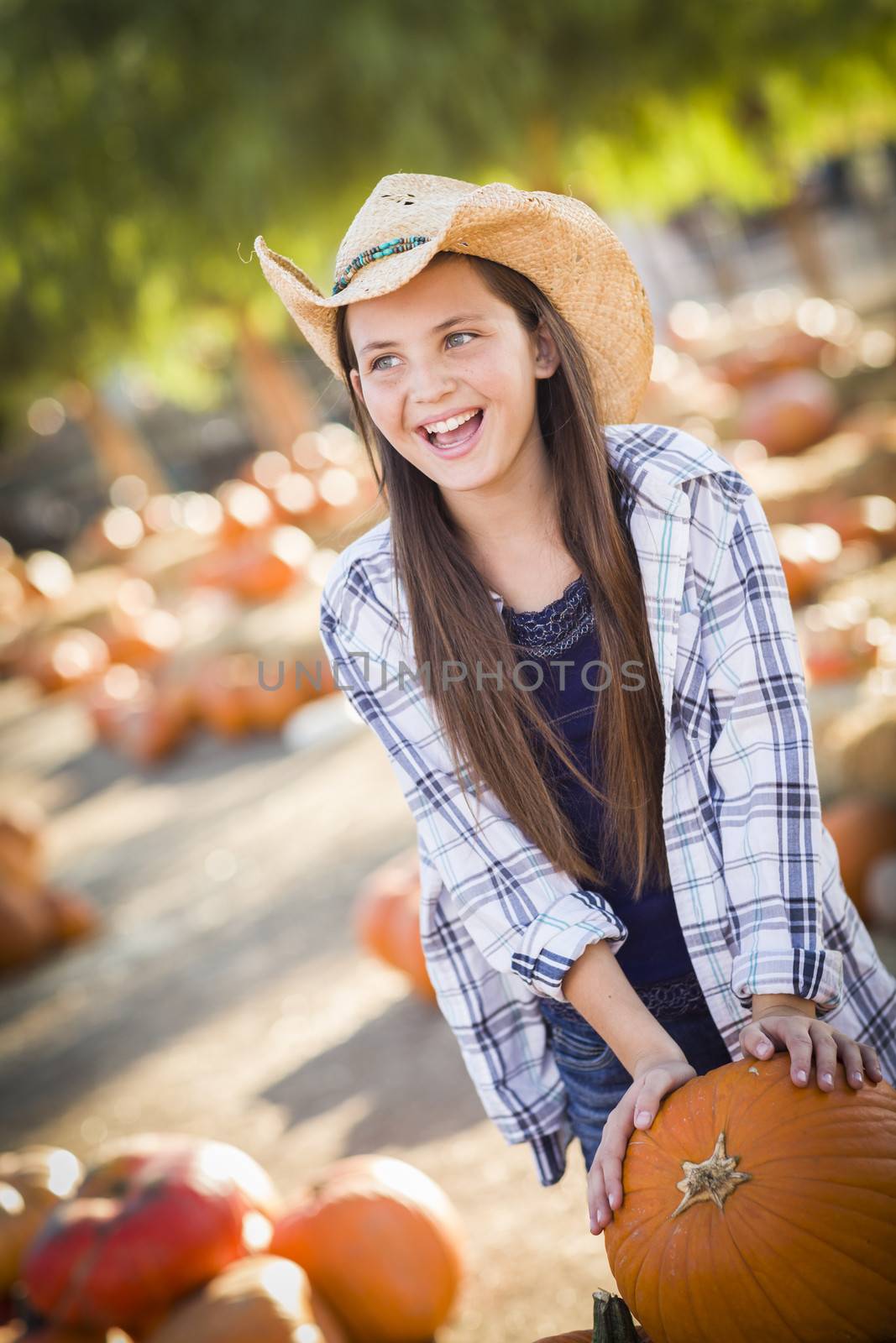 Preteen Girl Playing with a Wheelbarrow at the Pumpkin Patch
 by Feverpitched