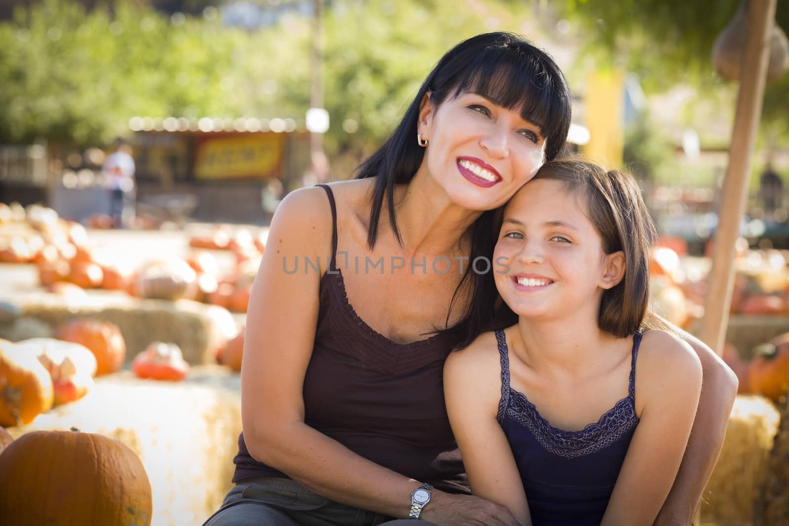 Attractive Mother and Daughter Portrait at the Pumpkin Patch
 by Feverpitched