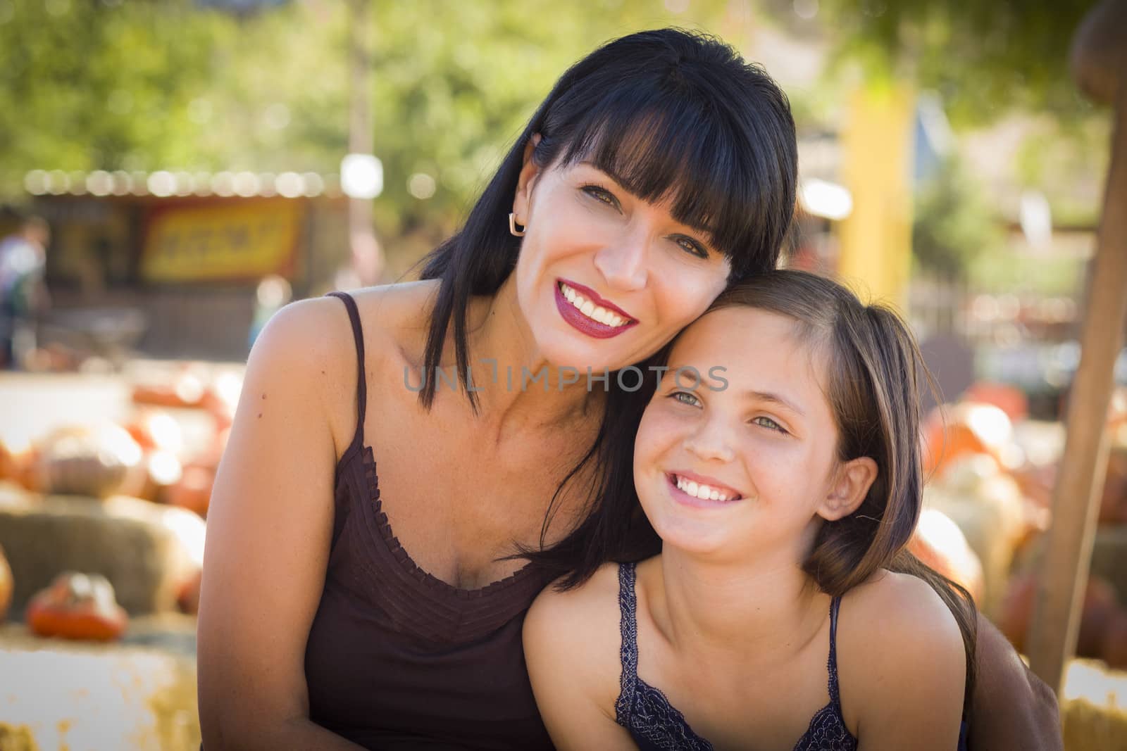 Attractive Mother and Daughter Portrait at the Pumpkin Patch
 by Feverpitched
