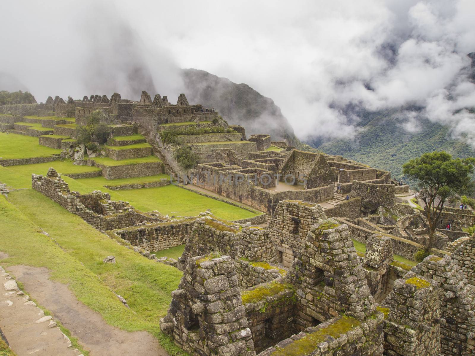 Ruins Buildings in Machu Picchu - Mysterious city and archaeological site of pre-Columbian civilization of the Incas on the Andes cordillera mountains archeology near Cusco, Peru.