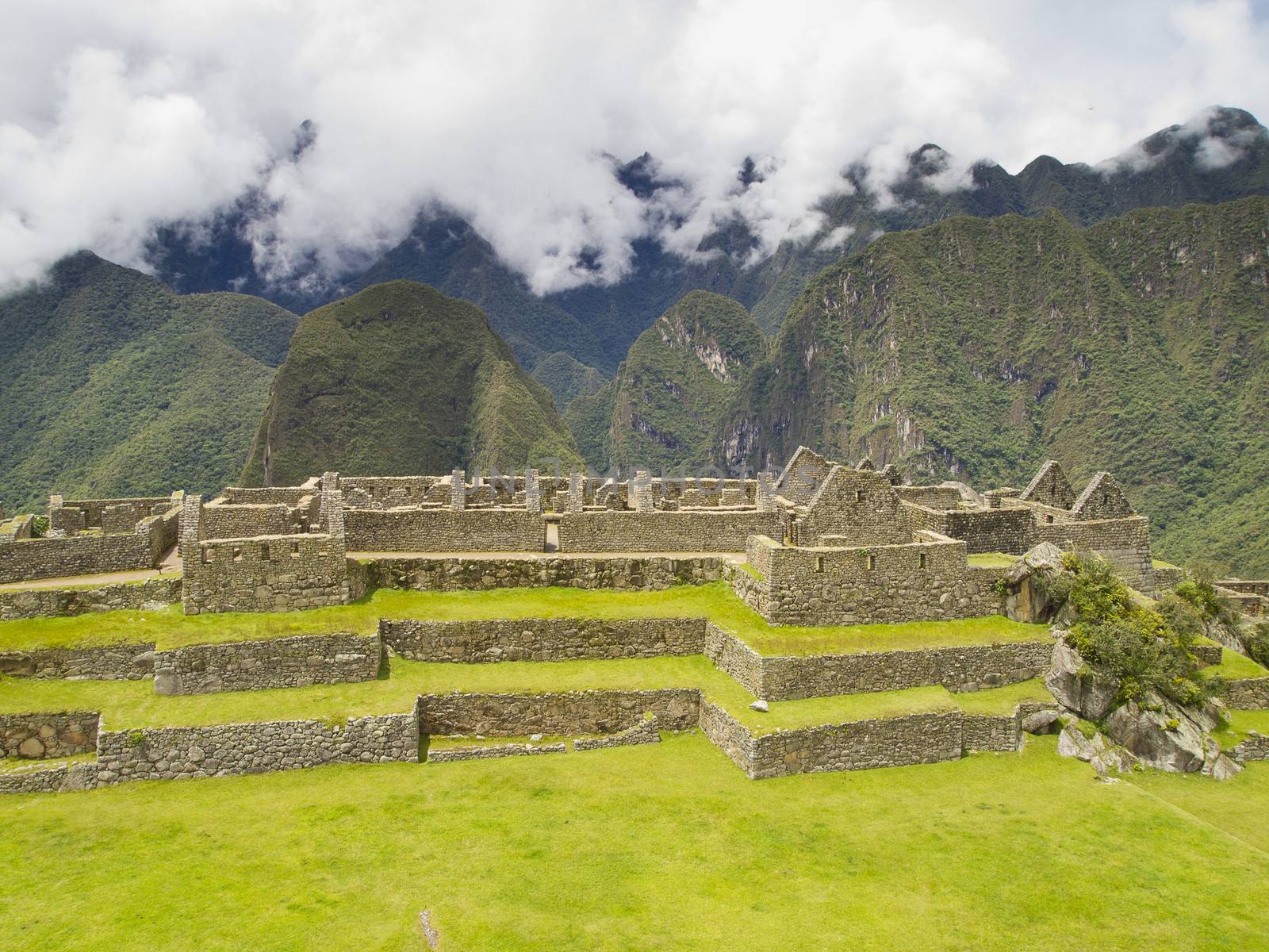 Ruins Buildings in Machu Picchu - Mysterious city and archaeological site of pre-Columbian civilization of the Incas on the Andes cordillera mountains archaeology near Cusco, Peru.