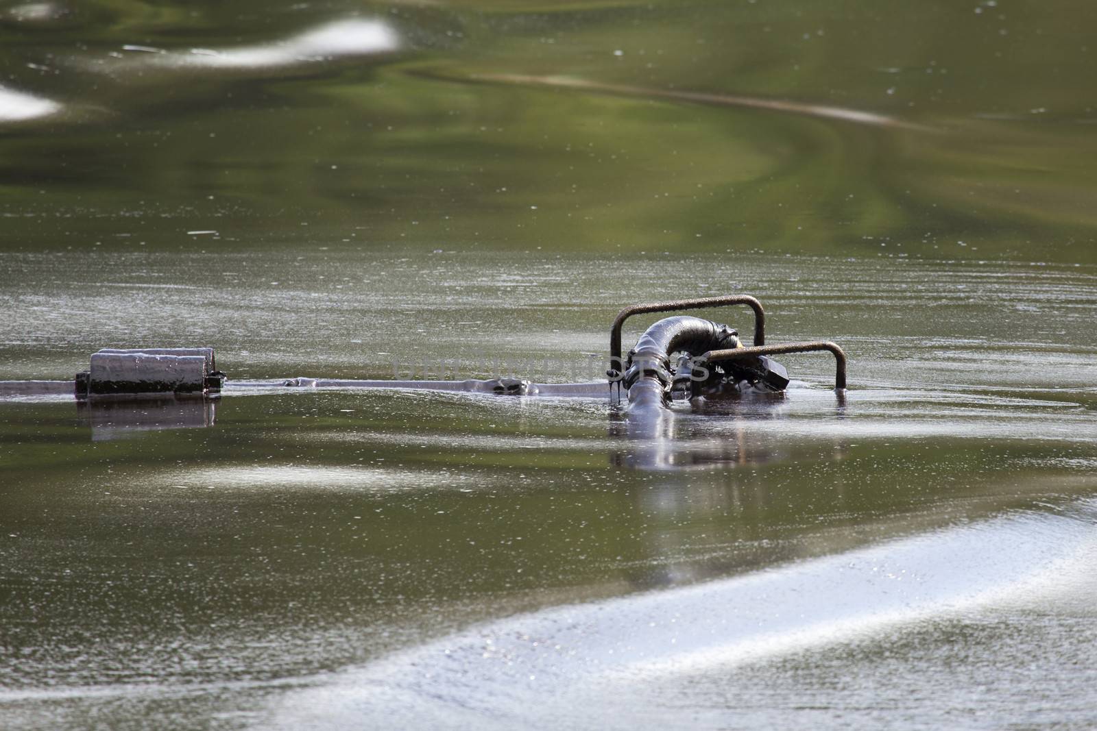 Oil pump soaked in crude oil spilled on the beach of Thailand