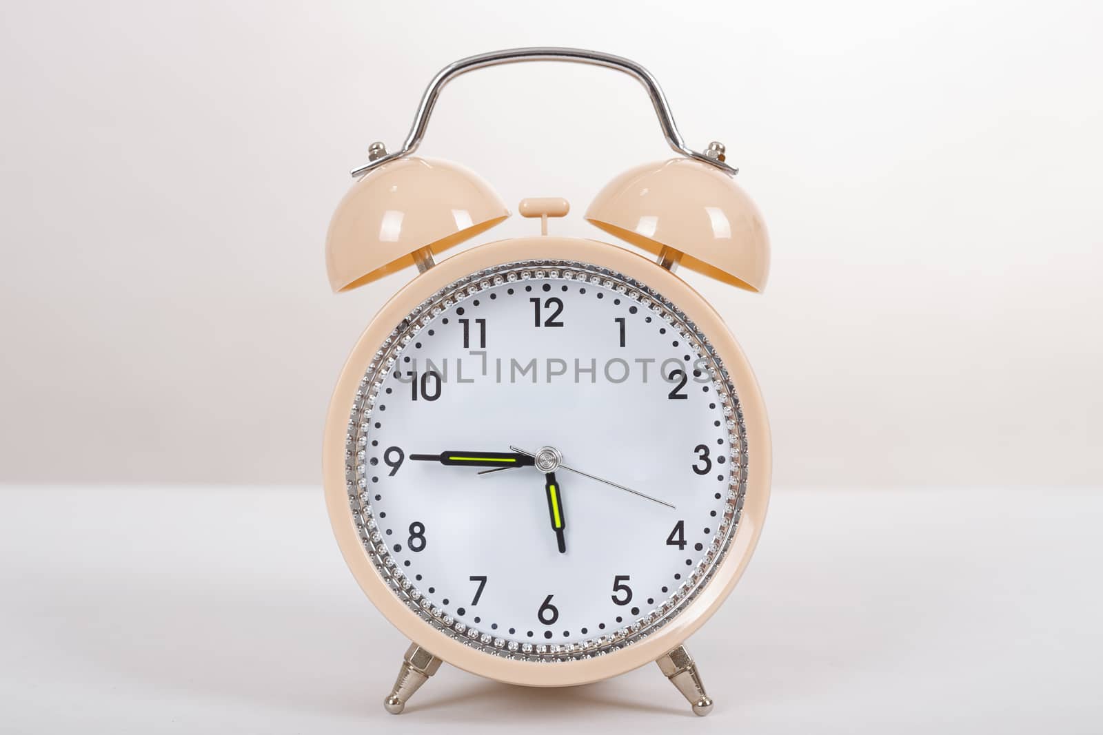 Alarm clock on a table on white table