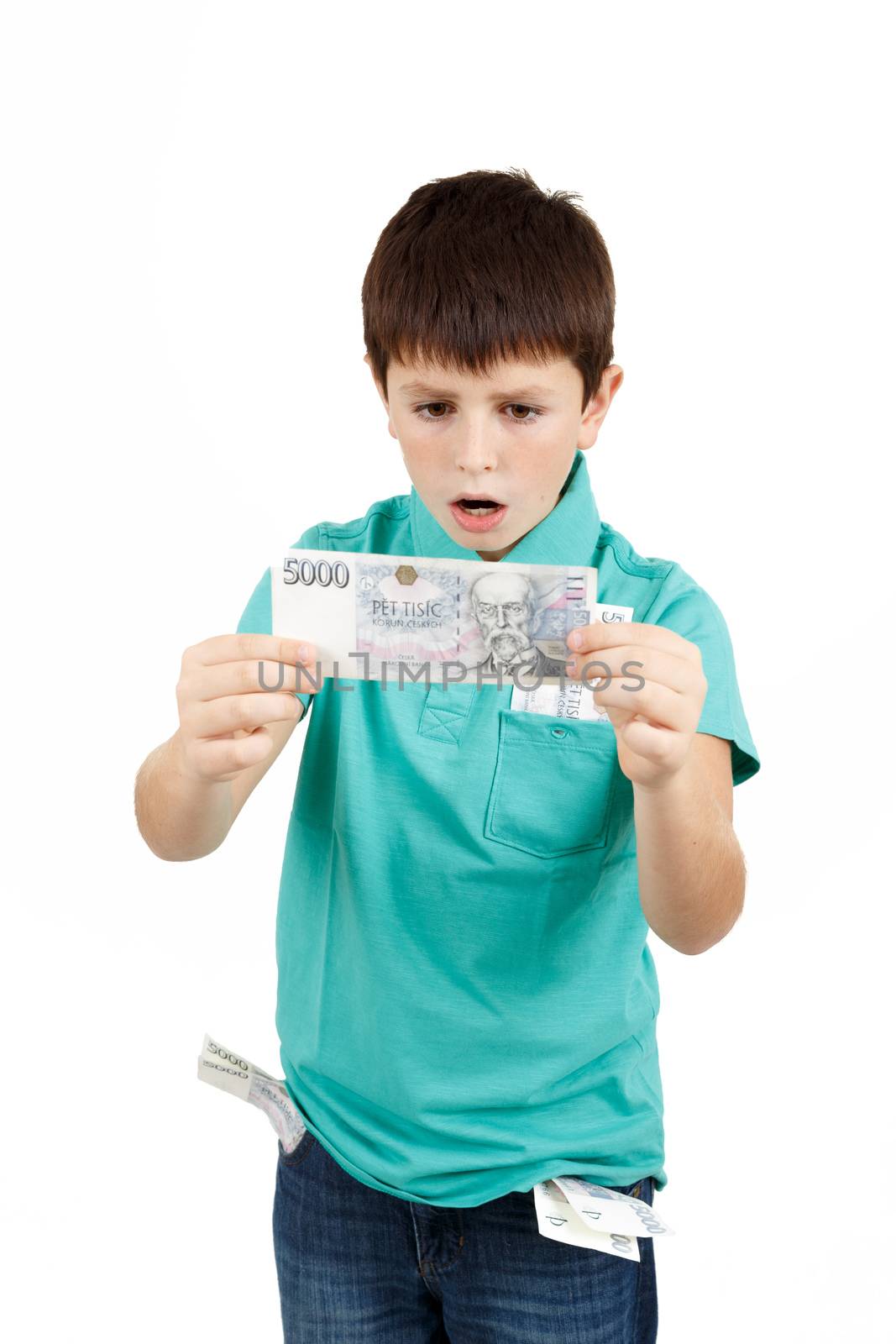 amazed boy looks at the bill from czech crown banknotes