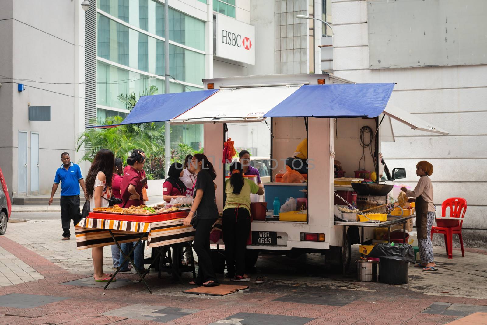 KUALA LUMPUR - JUN 15: Mobile vendor sell fast food on a street on Jun 15, 2013 in Kuala Lumpur, Malaysia. Street food is popular snack type in Asia. 