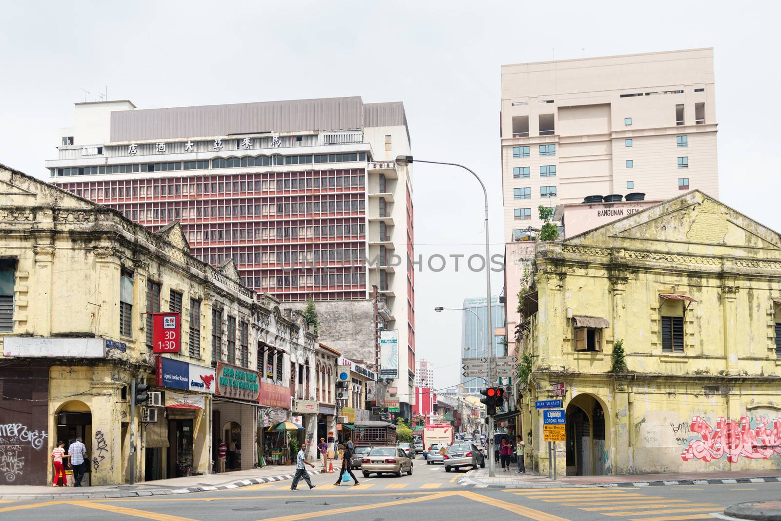 KUALA LUMPUR - JUN 15: Grecian-Spanish style buildings on Chinatown street on Jun 15, 2013 in Kuala Lumpur, Malaysia. Chinatown is home to much of the citys budget accommodation.