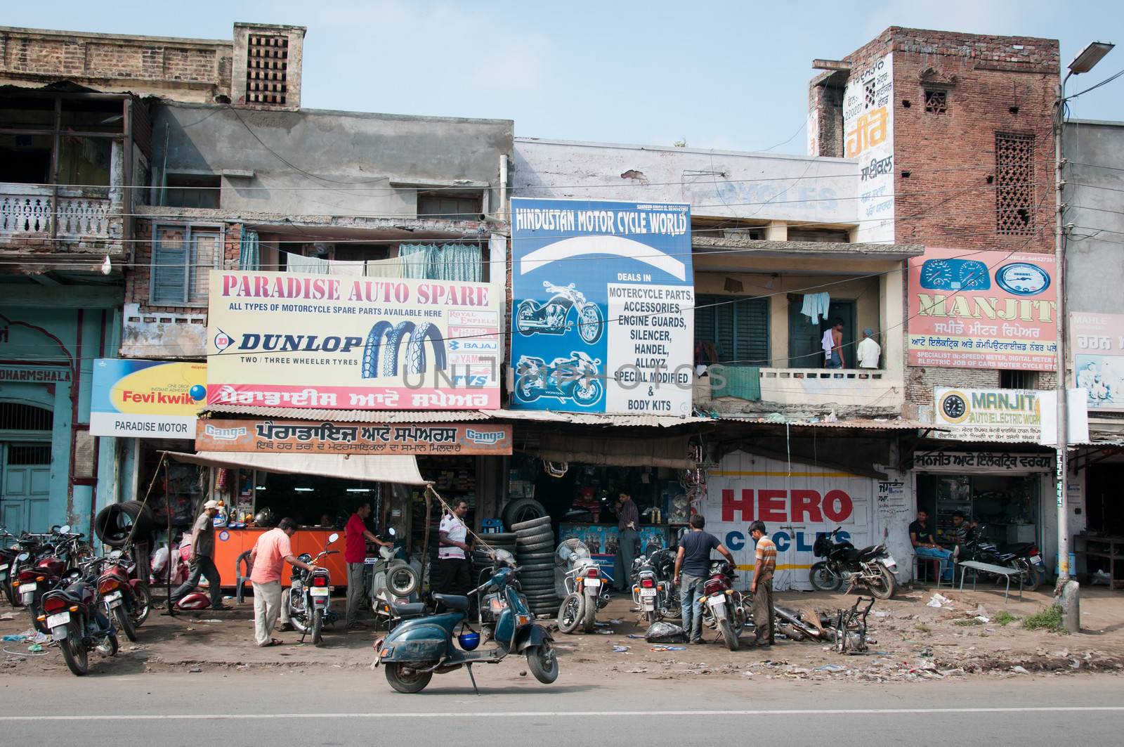 Chaotic motorbike repair service work, India by iryna_rasko