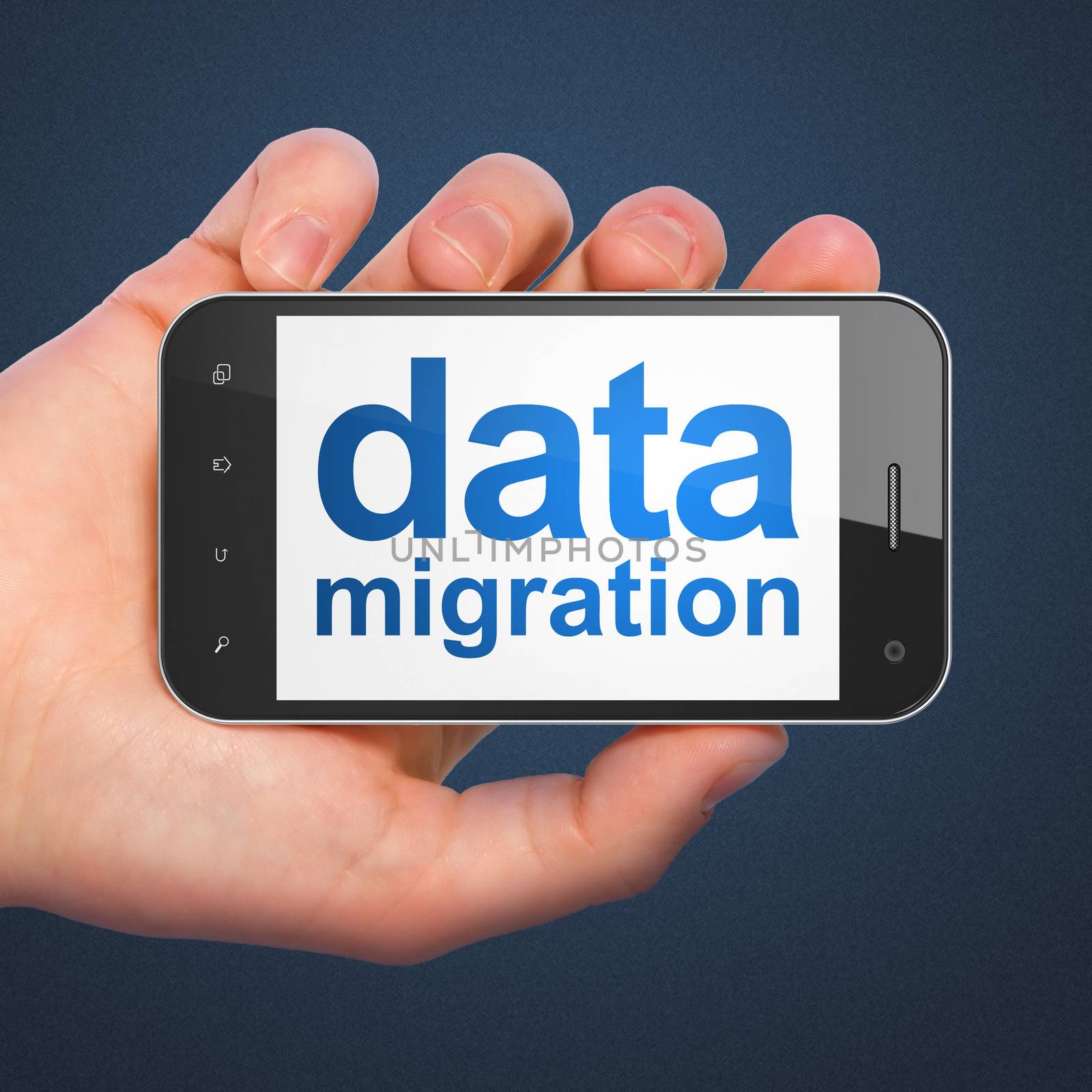 Information concept: hand holding smartphone with word Data Migration on display. Smart phone in hand on Dark Blue background.
