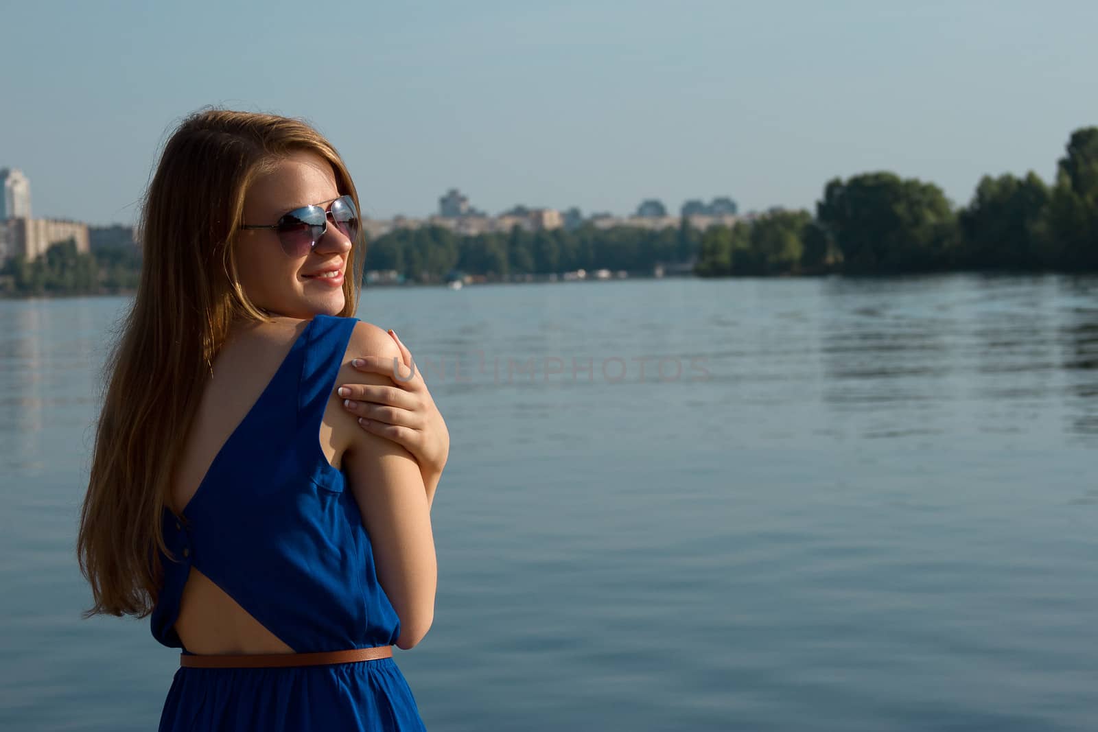 girl in a blue dress on the background of the river. Ukraine. Kiev. Obolon