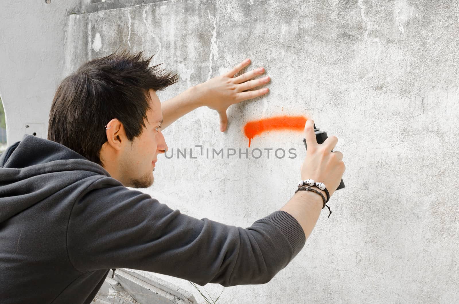 Graffiti artist about to start spraying a wall