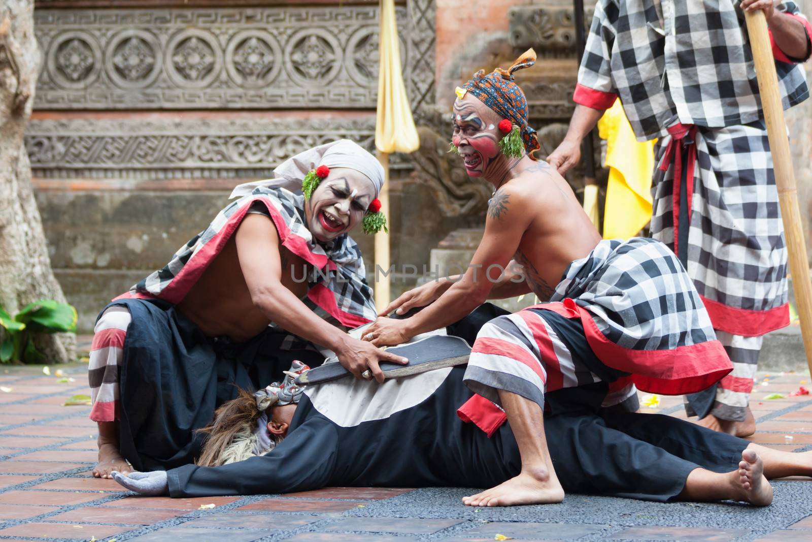 BALI - SEP 21: Clown Barong and Kris Dance performs at Sahadewah, in Batubulan, Bali, Indonesia on Sep 21, 2012. This famous play represents an fight between good and bad gods.