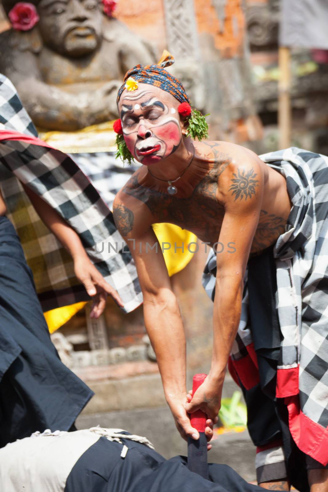 BALI - SEP 21: Clown Barong and Kris Dance performs at Sahadewah, in Batubulan, Bali, Indonesia on Sep 21, 2012. This famous play represents an fight between good and bad gods.