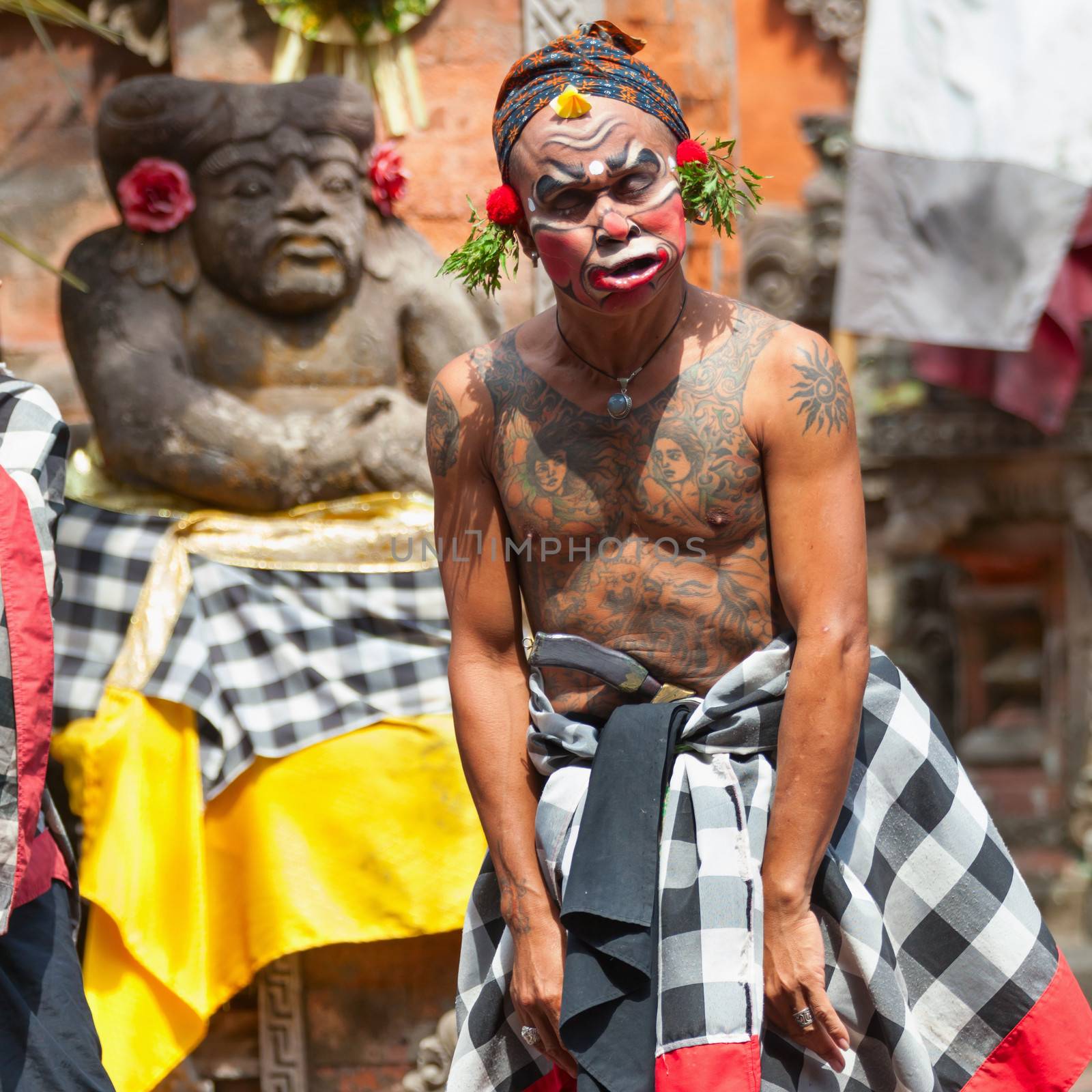 BALI - SEP 21: Clown Barong and Kris Dance performs at Sahadewah, in Batubulan, Bali, Indonesia on Sep 21, 2012. This famous play represents an fight between good and bad gods.