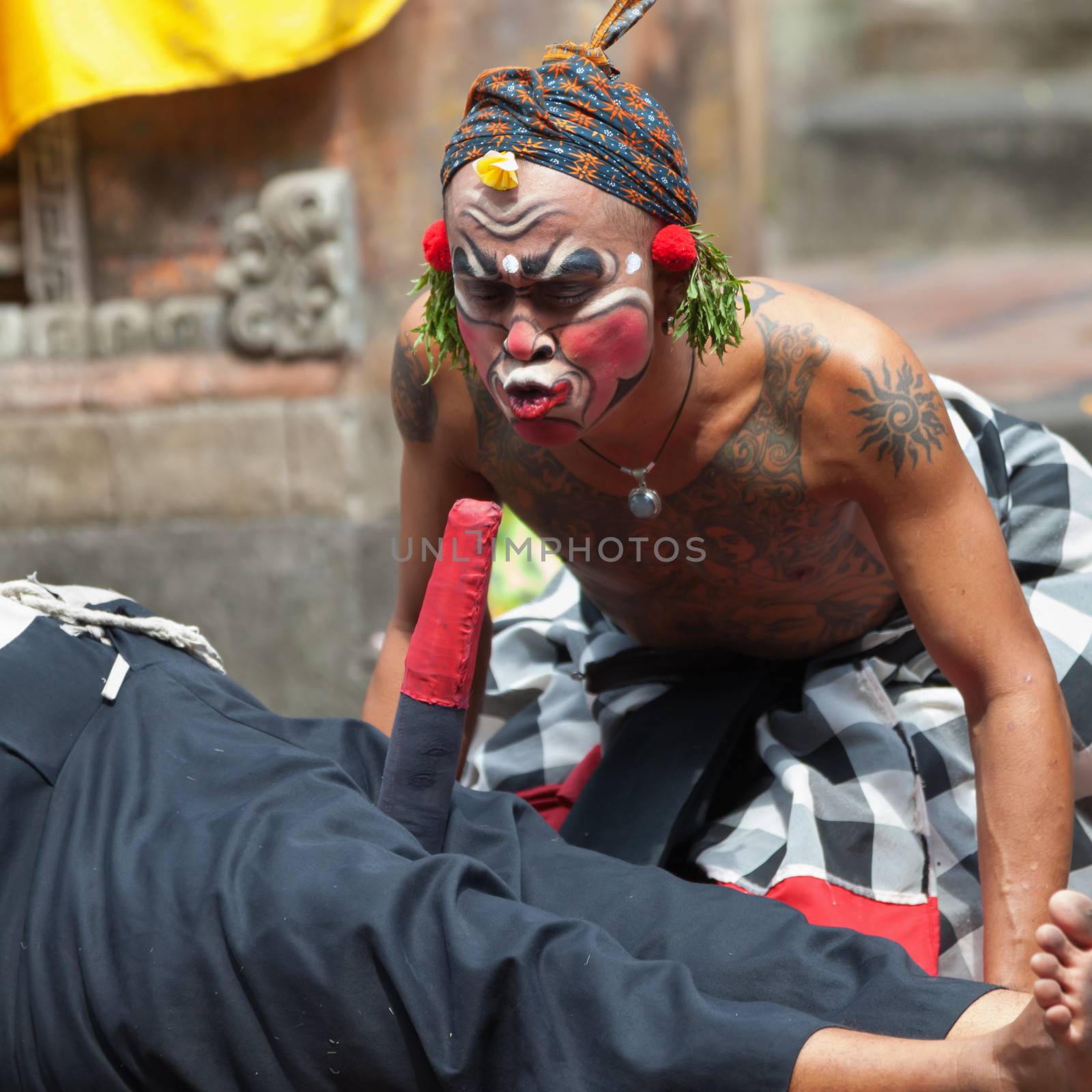 BALI - SEP 21: Clown Barong and Kris Dance performs at Sahadewah, in Batubulan, Bali, Indonesia on Sep 21, 2012. This famous play represents an fight between good and bad gods.