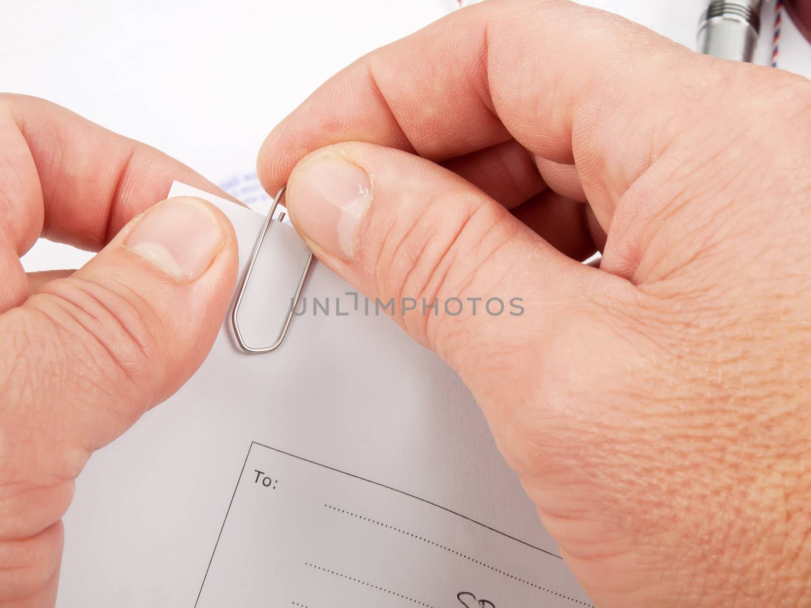 officer merge papers with paper clip in office 