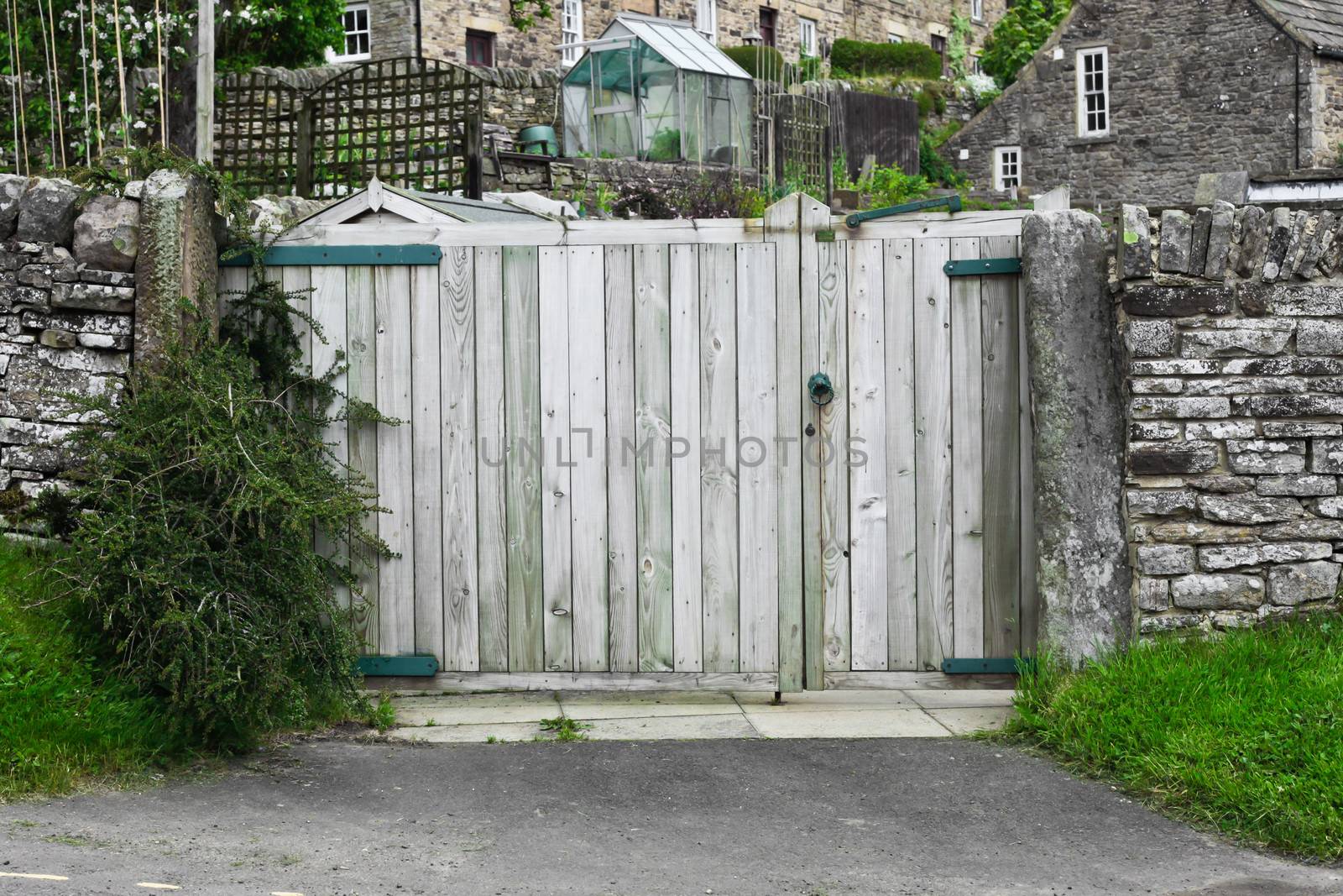 Wooden gate in a stone wall of an english house