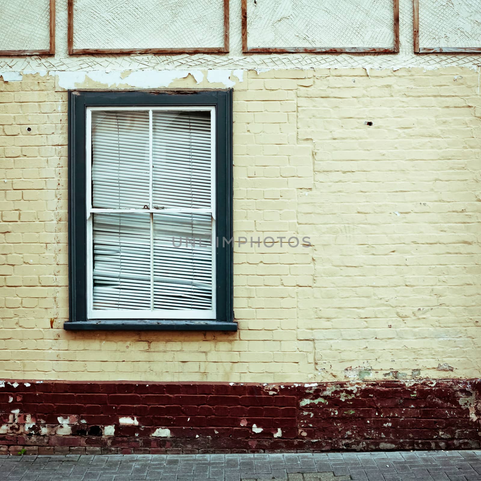 Window frame in a weathered wall of a house