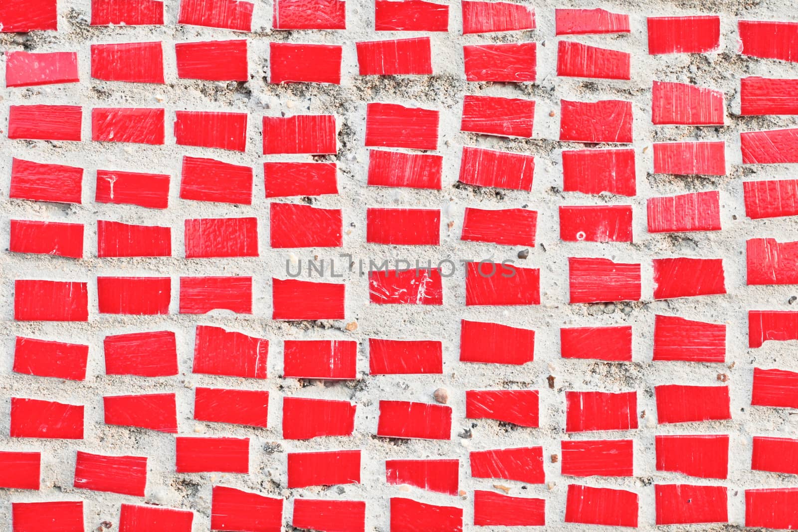 Small red tiles on a stone surface as a background