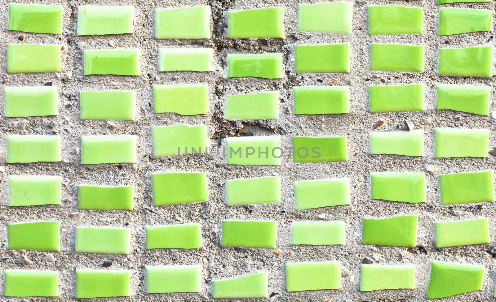 Small green tiles on a stone surface as a background