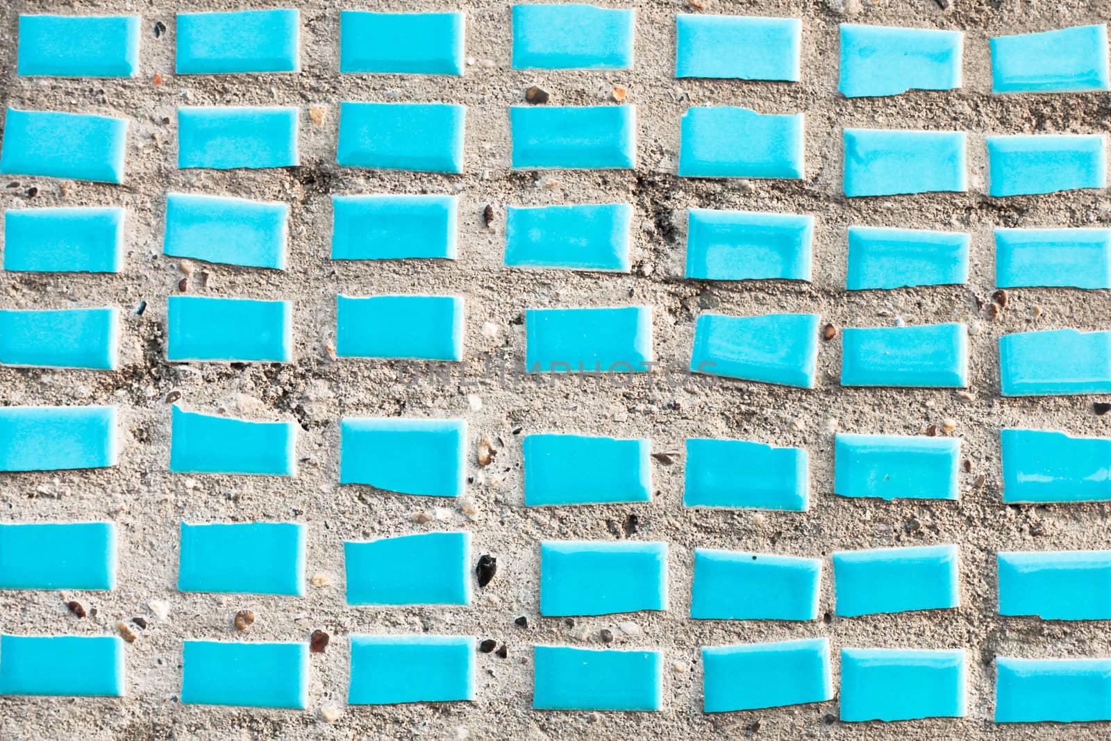 Small blue tiles on a stone surface as a background