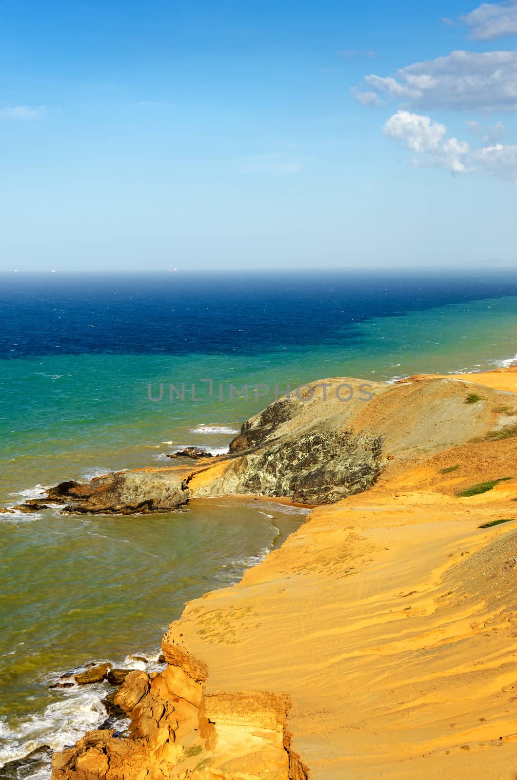 View of a dry desert coastline and the Caribbean Sea with various shades of blue near Cabo de la Vela in La Guajira, Colombia