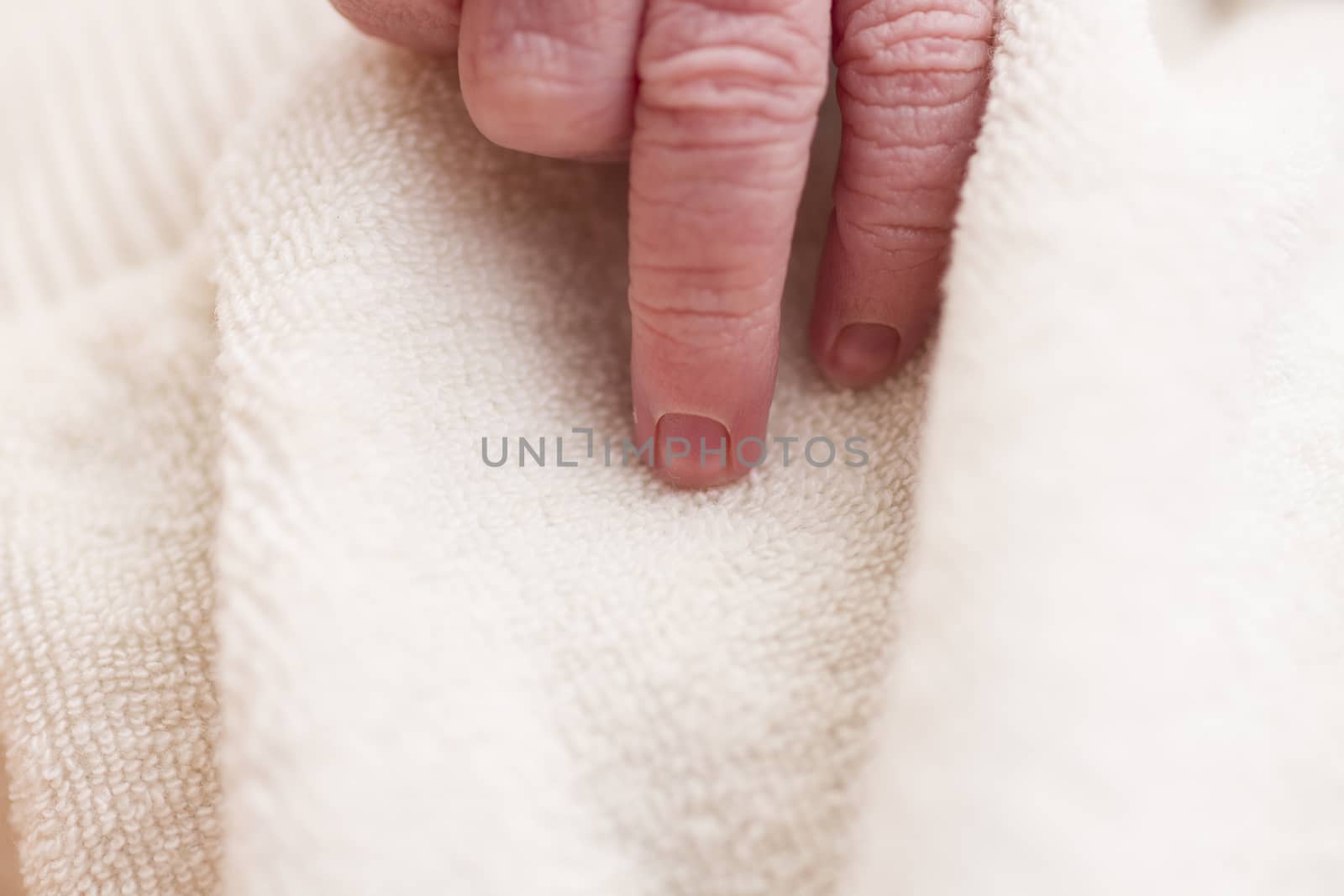 hand of new born baby in close up. vertical image
